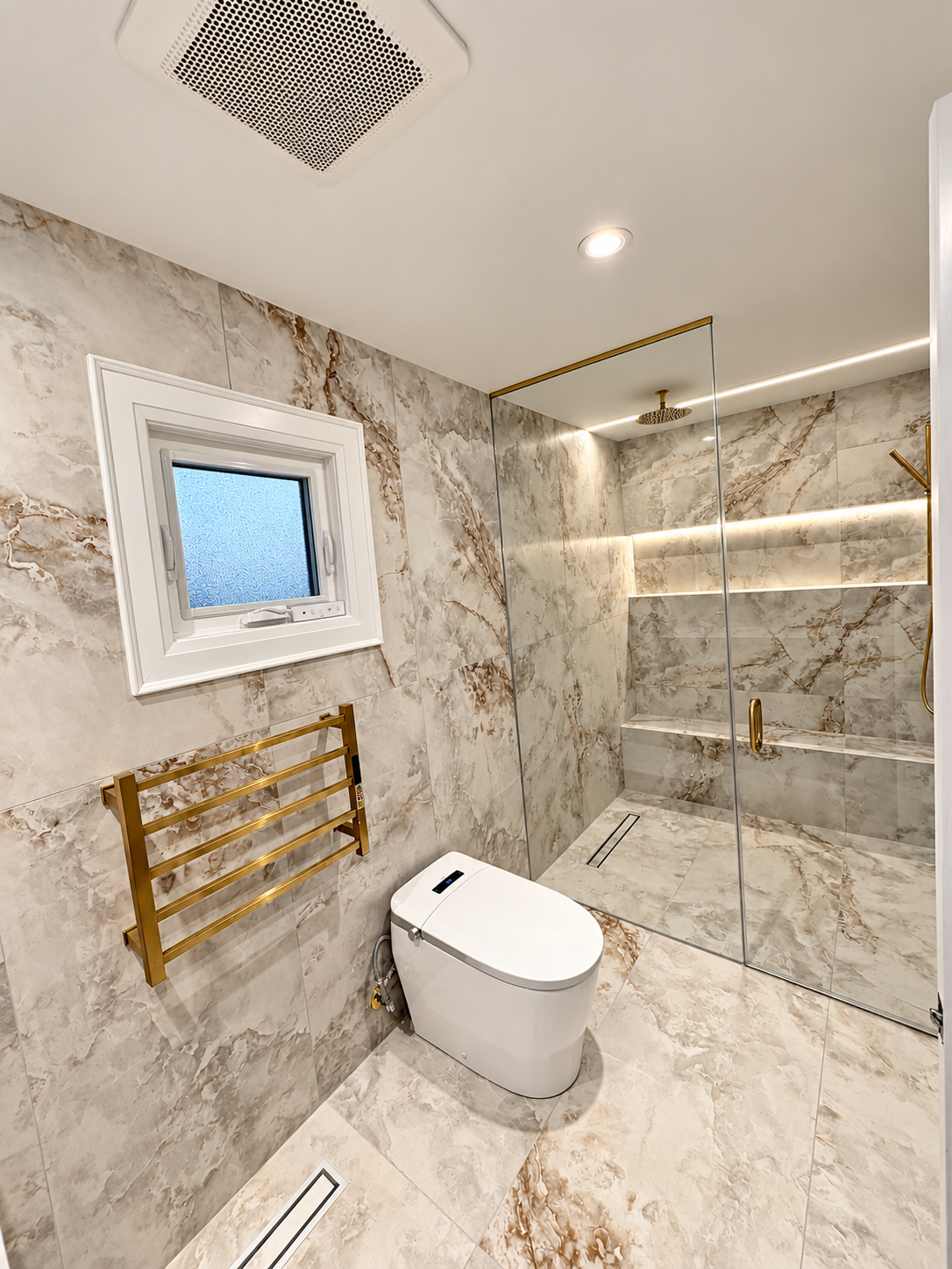 Completed ALCAN bathroom with a smart toilet, frameless glass shower and brushed-gold details